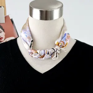 Exquisite silk square scarf featuring an artistic oil painting style, elegantly tied around the neck.