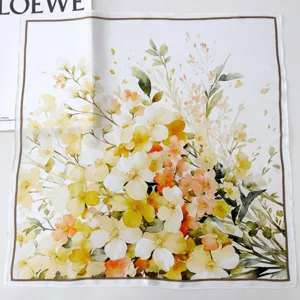 Pure silk square scarf with elegant watercolor yellow floral print, luxurious fashion accessory.