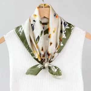 Close-up detail of the green oil-painting style floral silk scarf elegantly tied.