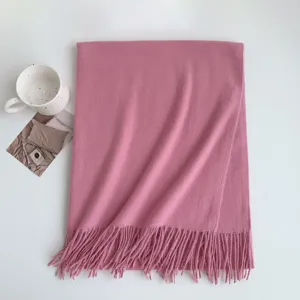 Detail view of the soft imitation cashmere scarf in solid pink purple with delicate fringe.