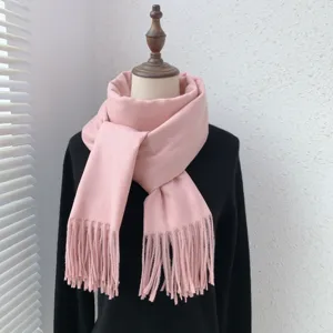 Pink tassel scarf detail view, soft imitation cashmere texture, winter cozy wear.