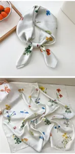 Nahaufnahme Detail des botanischen Seidenquadratschals mit weichem Stoff und Blumen.