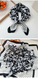 Detail view of black and white floral and polka dot silk square scarf, elegant neck accessory.