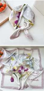 Damen Seidenschal mit Blumenmuster und rosa Rand, glatte weiche Stoffdetails.
