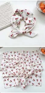 Detail view of cotton cherry print small square scarf, elegant neckerchief and headscarf.