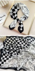 Dettaglio di foulard in seta a quadri bianco e nero con motivi artistici e ottima consistenza.