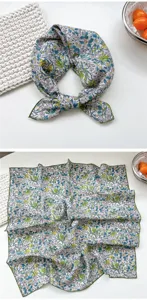 Detailed view of floral cotton square scarf, elegant floral pattern and green edge design.
