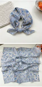 Detailed view of the elegant blue and white floral cotton square scarf, perfect neck wrap.