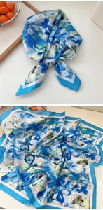 Close-up detail of the 70x70cm blue floral silk scarf showing the delicate watercolor print.