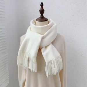Detail view of a cozy warm white solid color tassel scarf, perfect for winter daily wear.