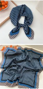 Detailed view of stylish blue geometric pattern silk square scarf, elegant neck accessory.