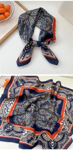 Detail view of the elegant blue and orange paisley print silk square scarf close up.
