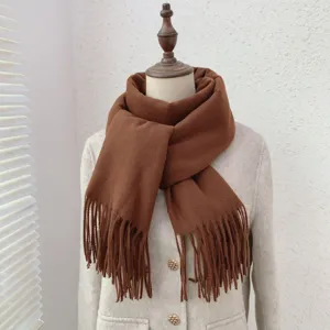 Detailed view of an elegant brown cashmere-like fringed winter scarf displayed on mannequin.