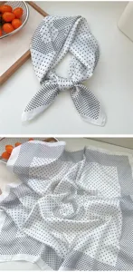Detailed view of white silk square scarf featuring black polka dots and number print, elegant accessory.