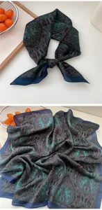 Close-up detail of the elegant 70x70cm dark blue and turquoise paisley silk square scarf.