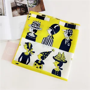Detailed view of women's silk square scarf featuring artistic cartoon character print, vibrant yellow.