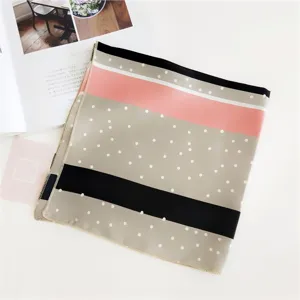 Detailed close-up shot of the stylish polka dot and color block silk small square scarf.