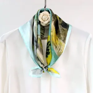 Silk square scarf featuring an artistic landscape watercolor design with soft blue border.