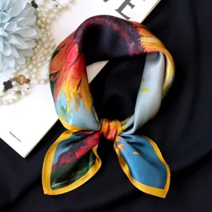 Detailed view of silk square scarf with colorful oil painting floral print and glossy finish.