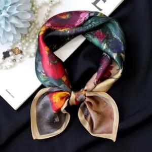 Silk square scarf detail showing vibrant oil painting print and smooth satin texture.