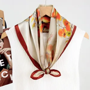 Exquisite silk square scarf featuring an elegant oil painting fruit print with a classic red border.