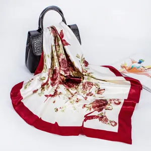 Detailed view of a 90cm satin silk square scarf featuring vintage rose floral print and red border.