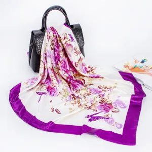 Detailed view of a satin floral silk scarf draped elegantly, showing smooth texture and print.