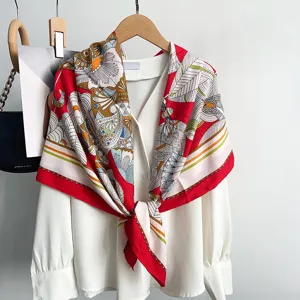 Detailed close-up view of vintage floral print square scarf elegantly draped on white blouse.