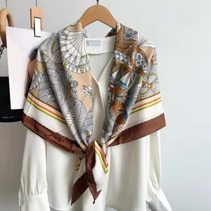 Detailed view of retro geometric silk feel square scarf with floral print and brown border.