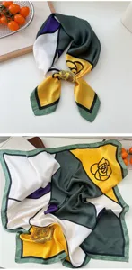 Detailed view of women's silk square scarf with chic geometric color block and floral design.
