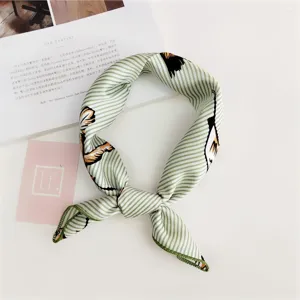 Green and white striped silk scarf detail, elegant small square neckerchief decoration.