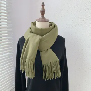Detailed view of the elegant olive green solid color tassel scarf showcasing texture.