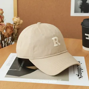 Beige embroidered letter baseball cap, soft top casual hat for men and women daily wear.
