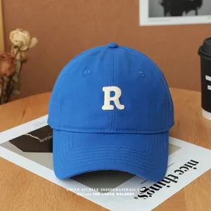 Blue baseball cap with white embroidered letter R, casual soft top hat for men and women.