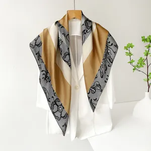 Detailed shot of a luxury satin square scarf featuring elegant lace geometric patterns.