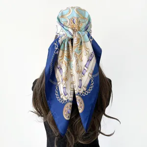 Back view detail of a blue satin silk square scarf tied on hair with retro chain print.