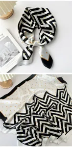 Detailed view of a chic black and white polka dot silk square scarf, elegant neck accessory.