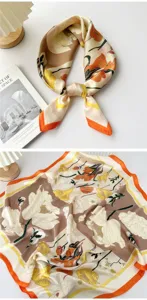 Detailed close-up view of the silky square scarf featuring retro floral print and orange border.