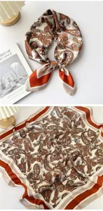 Detailed close-up of the elegant paisley silk scarf showing the delicate brown and white pattern texture.