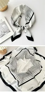 Detailed view of a black and white geometric printed square silk scarf, stylish neckerchief.