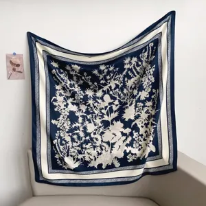 Elegant navy blue square silk scarf with botanical print, luxury style headscarf for women.