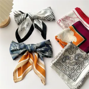 Stylish women silk square scarves set, featuring elegant bow tied and folded styles with paisley patterns.