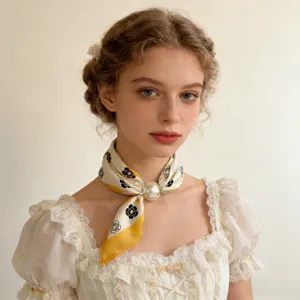 Close-up detail of vintage floral silk scarf with pearl magnetic clasp for elegant style.