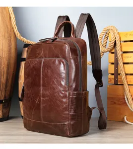 Detailed view of the dark brown genuine leather backpack featuring a front pocket and durable straps.