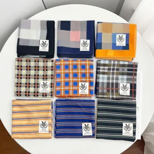 Detail view of multicolored cotton patterned square scarves featuring geometric and stripe designs.