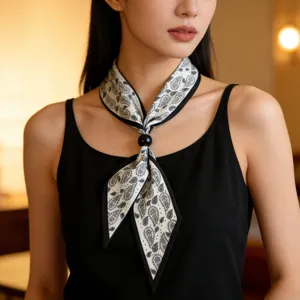 Detailed view of summer minimalist black and white paisley narrow silk scarf necklace.