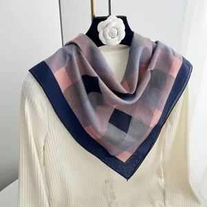 Exquisite geometric plaid pattern scarf close-up, showing elegant drape and soft fabric texture.