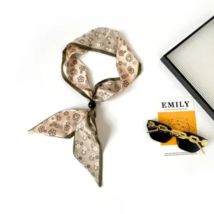 Silk scarf with beaded detail, floral print neck scarf, elegant fashion accessory detail.