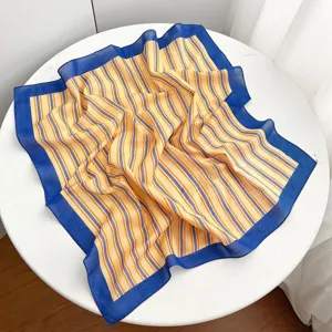Striped cotton square scarf detail showcasing fabric texture and vibrant blue border design.