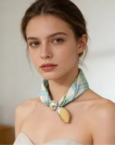 Close-up of a blue and white plaid neckerchief with a stylish magnetic pearl buckle detail.